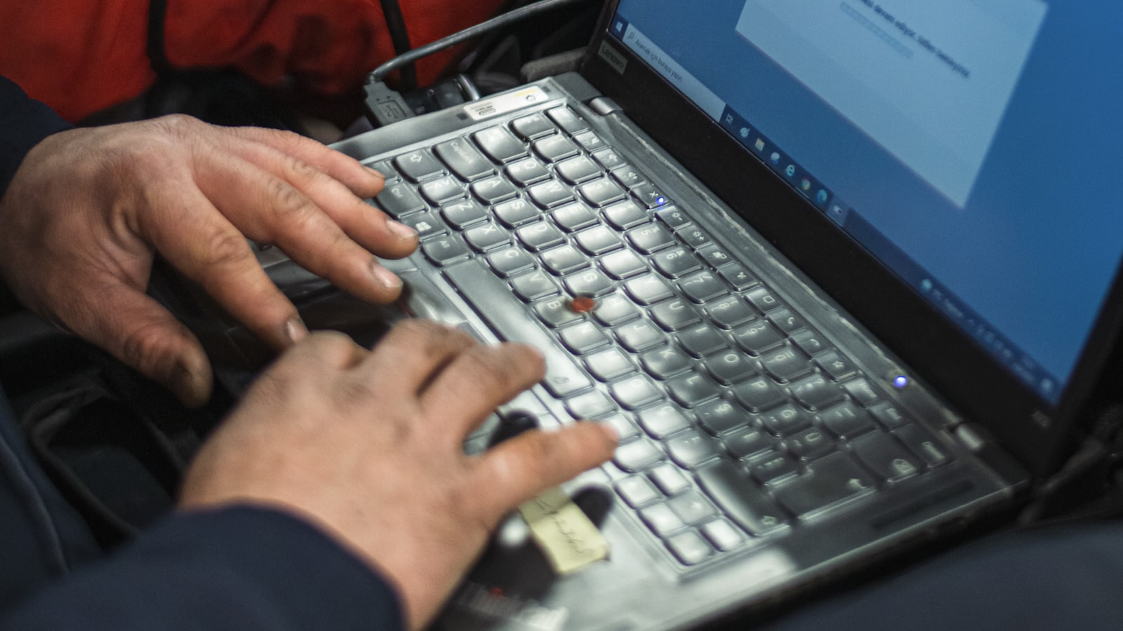 A diagnostic laptop connected to a car to read fault codes